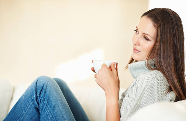 istock Woman relaxing in couch 184154347
