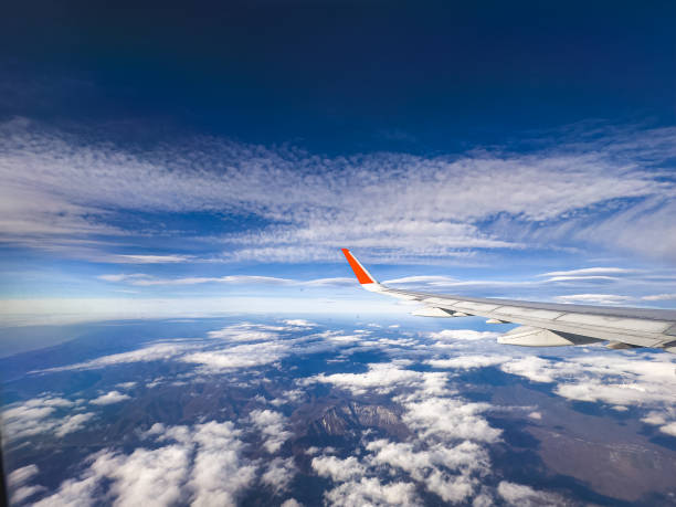 istock View of clouds and blue sky from an airplane window 1841544200
