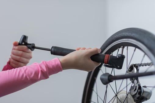 female carry out bicycle maintenance at home