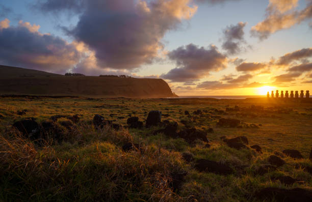 Dramatic colorful sunrise over Moai stone sculptures at Ahu Tongariki, Easter island, Chile.