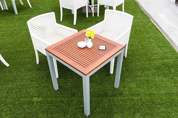 istock Tropical wooden dinning table on green grass 184167414
