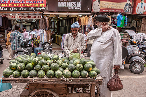 Amritsar, Punjab, India, May 07th 2012: In hat summer time Water melons are on sale on a cart at roadside in main market area in Amritsar city, Punjab