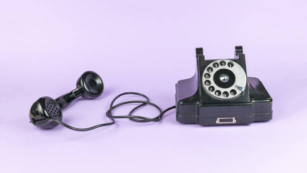 istock Black vintage handset with the handset off on a purple background. 1841693877