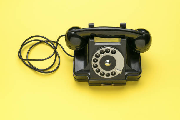 istock Retro vintage telephone on a yellow background. The old technique. 1841693899
