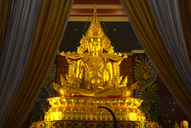 Phra Buddha Hiranrat His body was dressed in royal garb in the pose of bestowing blessings as the principal Buddha image. At Sacred Hall in Wat Tha Mai temple. Located at Samut Sakhon Province in Thailand.