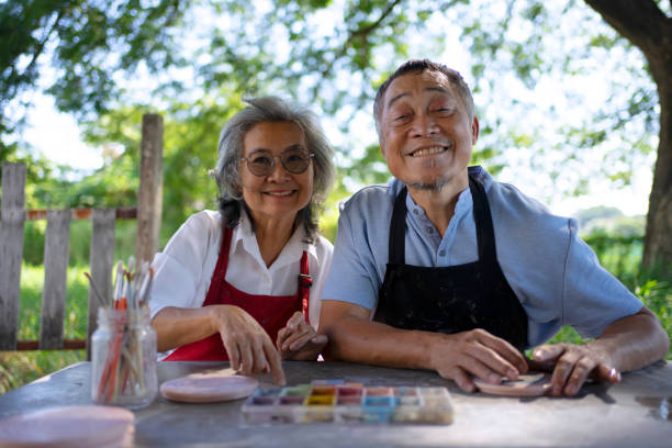 istock Senior couple learn how to make pottery. 1841727299