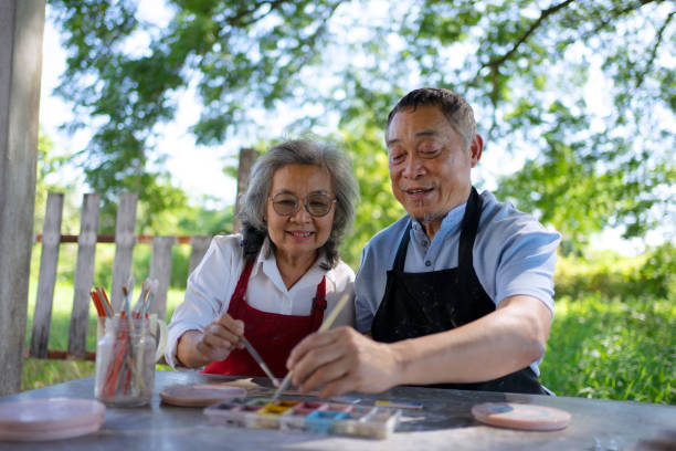 Senior couple learn how to make pottery.