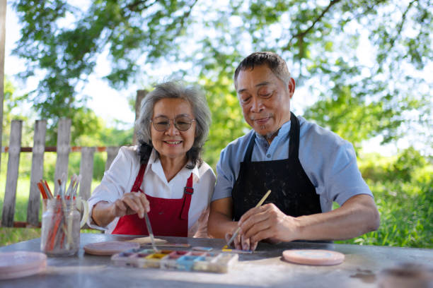 istock Senior couple learn how to make pottery. 1841727813