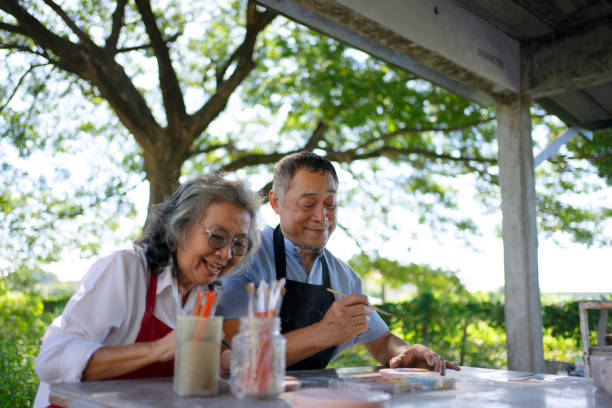 istock Senior couple learn how to make pottery. 1841727817