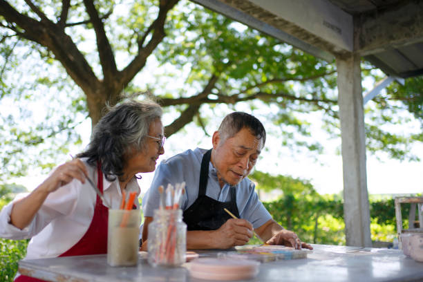 istock Senior couple learn how to make pottery. 1841727822