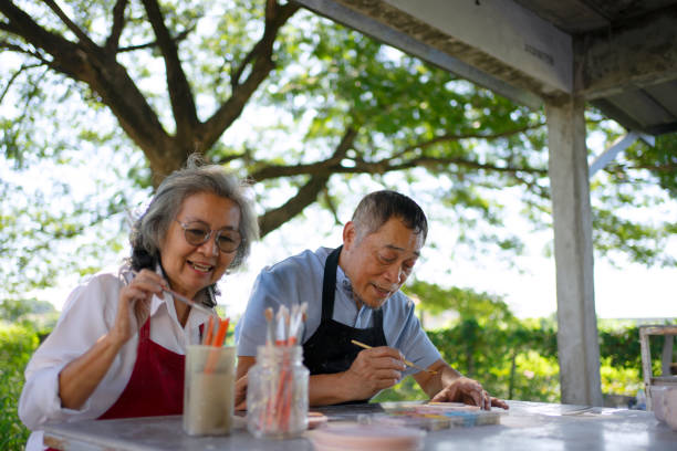 istock Senior couple learn how to make pottery. 1841735552
