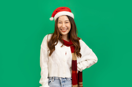 Happy smiling asian woman holding gift box over red background.