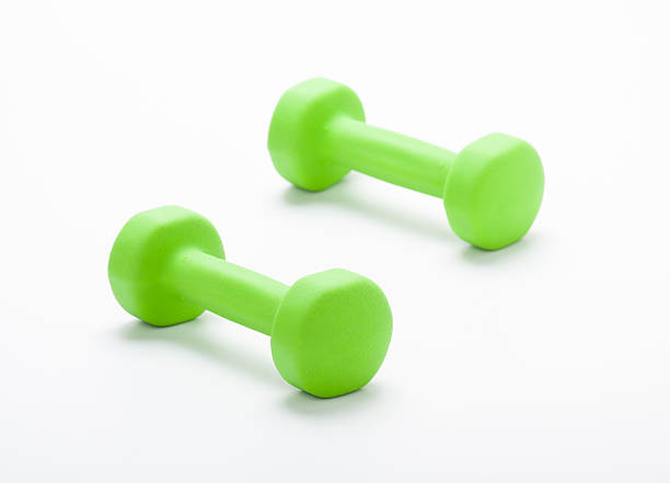 istock small green dumbbells,  isolated in white background 184179227