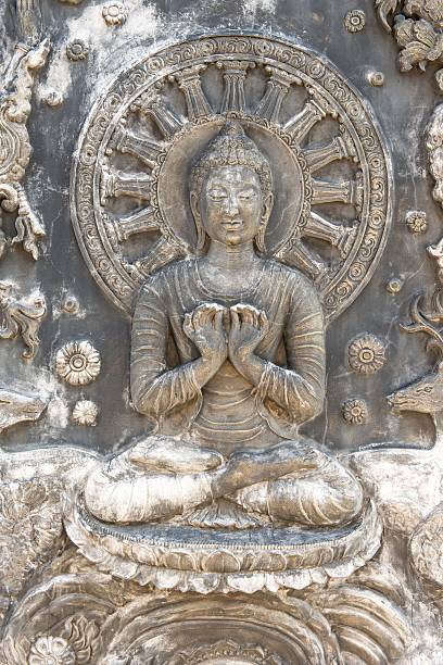 istock Ancient old vintage buddha sculpture on the wall 184180325