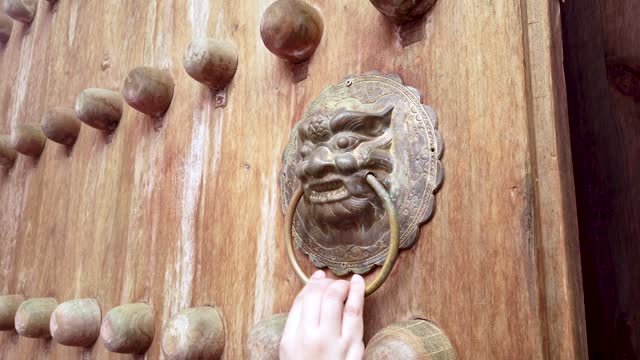 Woman Knocking the Chinese gate handle