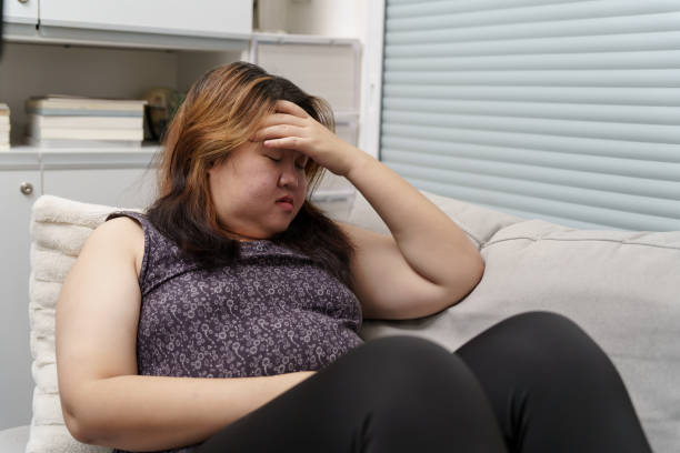 istock Sad Overweight plus size woman thinking about problems on sofa upset girl feeling lonely and sad from bad relationship or Depressed woman disorder mental health 1841823471