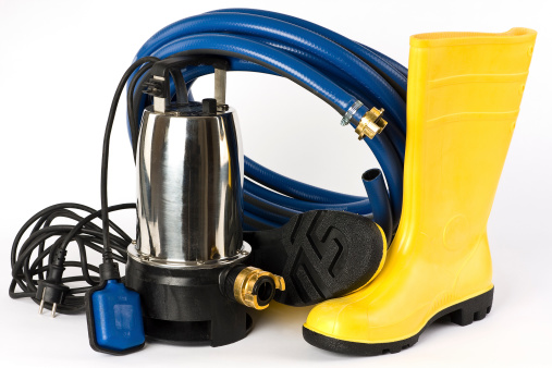 Submersible pump, rubber boots and water hose shown on a white background.