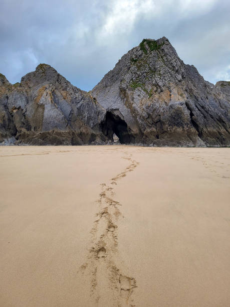 istock Three Cliffs Bay on Gower Peninsular - footprints in the sand. 1841826114