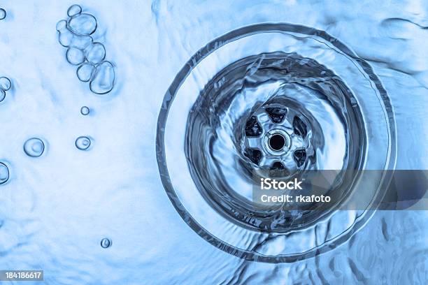 Closeup Of Water Draining In An Aluminum Kitchen Sink Stock Photo - Download Image Now