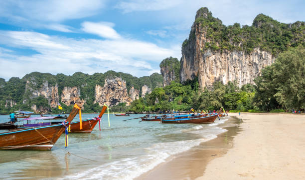 istock Thai longboat and white sandy beach in the tropics 1841910598