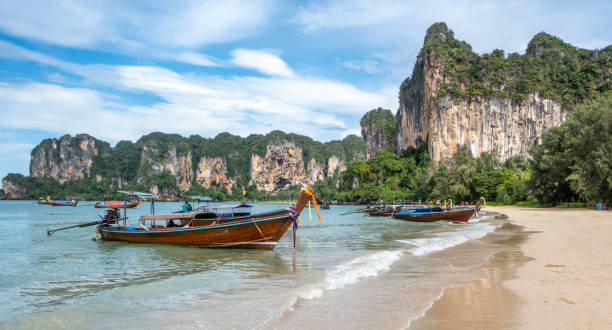 istock Thai longboat and white sandy beach in the tropics 1841911632