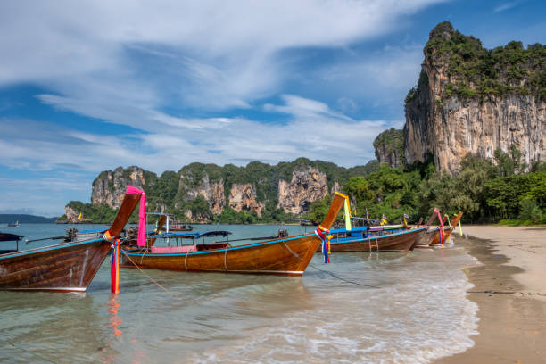 istock Thai longboat and white sandy beach in the tropics 1841911634