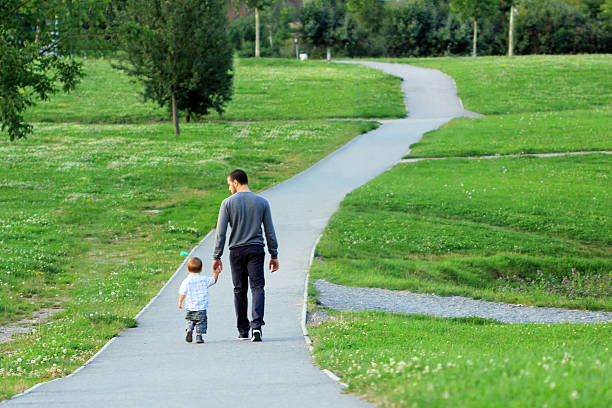 istock Father and son walking in a park 184191216