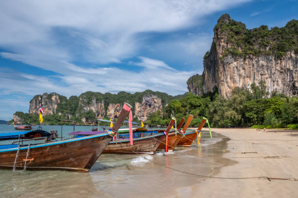 istock Thai longboat and white sandy beach in the tropics 1841912186