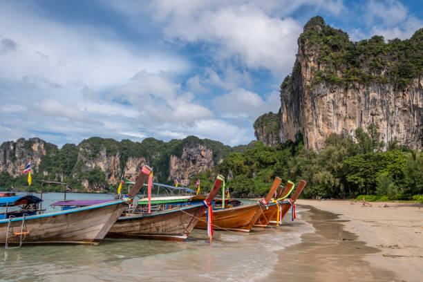 istock Thai longboat and white sandy beach in the tropics 1841914243
