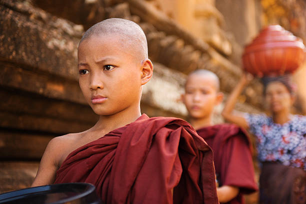 istock Southeast Asian young Buddhist monks walking morning alms 184194563