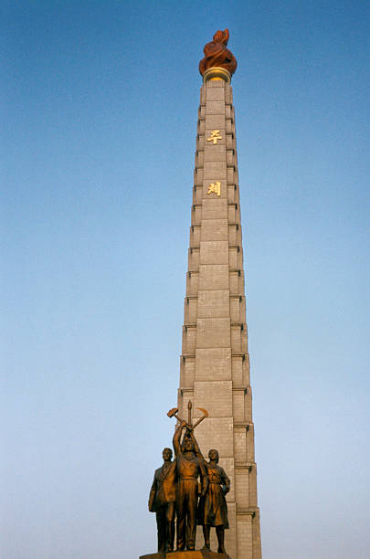 istock Pyongyang, North Korea: Juche Tower with central statues 184194854