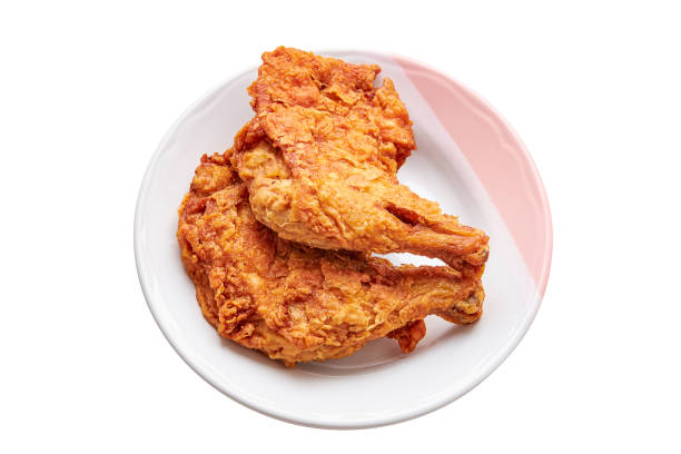 istock 2 large chicken thighs batter and deep fried in plate isolated on white background. fried chicken is a dish consisting of chicken pieces that have been coated with seasoned flour or batter. 1841956162
