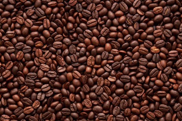 istock Top view of roasted coffee beans background on flat lay, surface, texture, Roasted coffee beans is a fruit from the Coffee plant. This fruit is often referred to as a coffee cherry. 1841957241