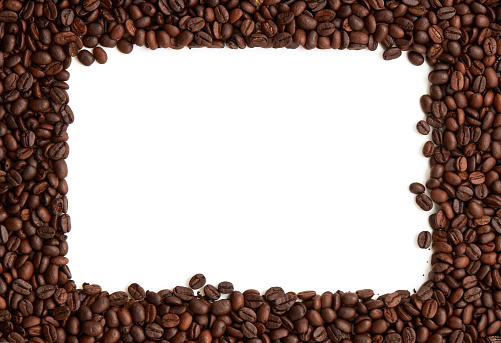 Top view of roasted coffee beans texture background on flat lay in horizontal with white free space in center. pattern for design menu drink. coffee beans frame.