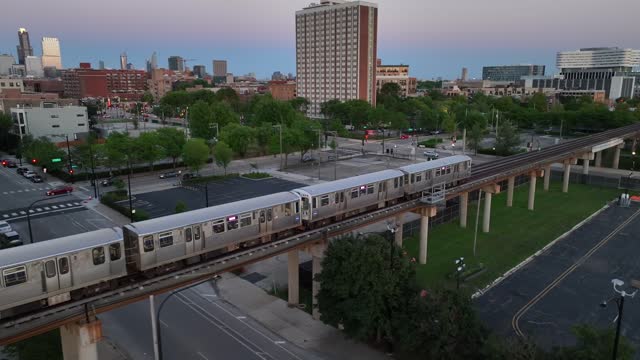 Elevated train in Chicago. Aerial tracking shot of public transportation at dusk. Passenger subway.