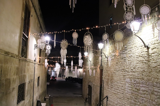 Bitonto, Metropolitan city of Bari, Italy - 8 december 2023: alley in the historic center illuminated with Christmas lights and decorations.