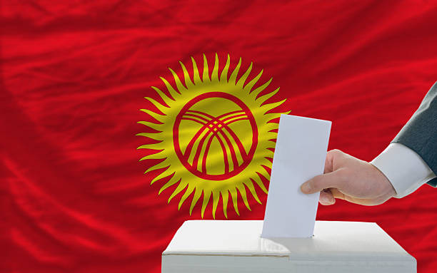 istock man voting on elections in kyrghyzstan front of flag 184199349
