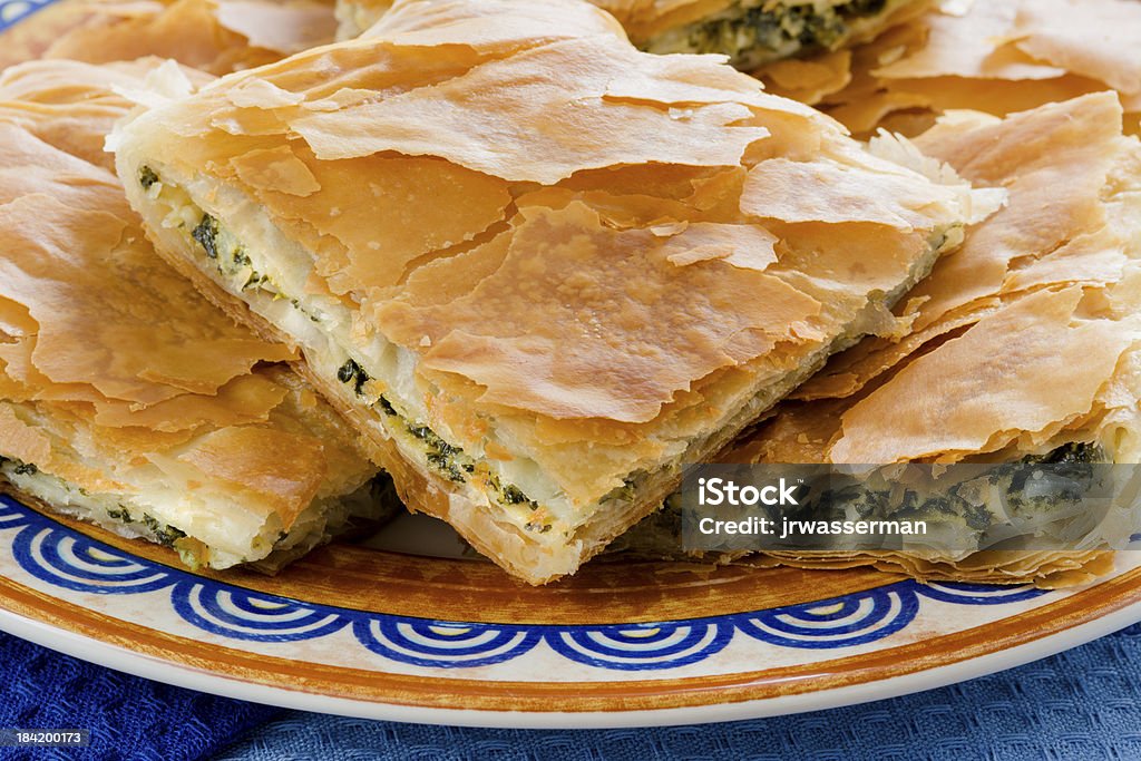 OPA! Spanakopita - Greek Spinach Pie in Close Spanakopita, Greek spinach pie with feta cheese and filo party on on plate Appetizer Stock Photo