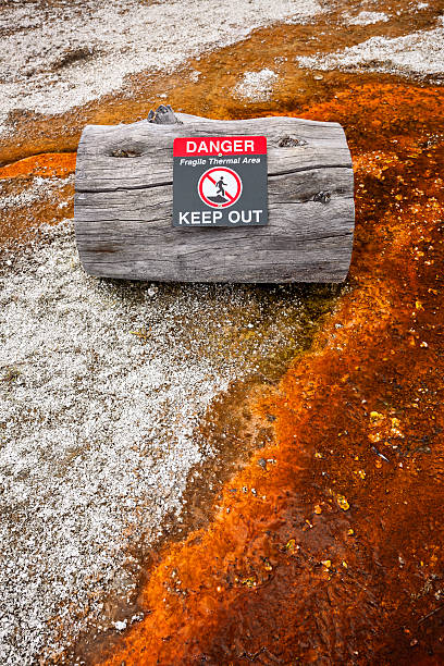 Warning sign telling of geothermal danger in West Thumb Geyser Basin, Yellowstone National Park, Wyoming