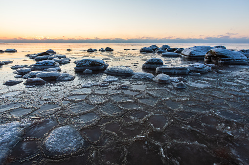 Stones and freezing water on the beach in Vidzeme near Veczemju cliffs