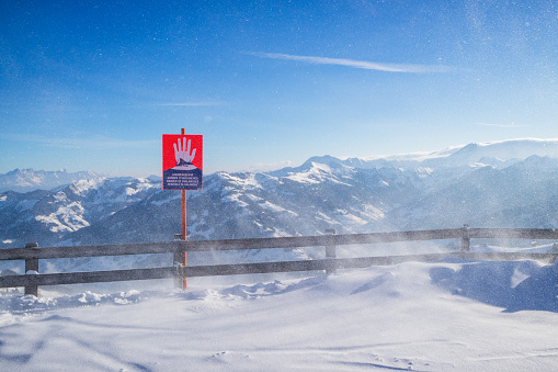 Empty airport runway at winter day on the background of high scenic snow capped mountains