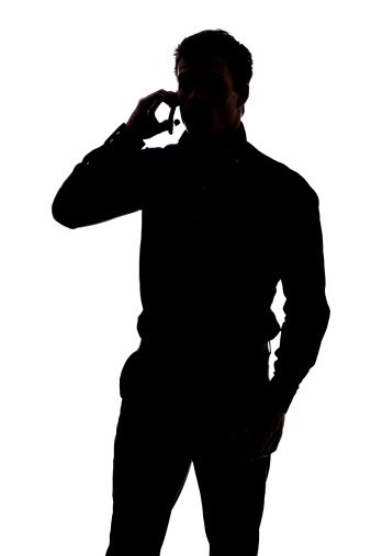 Man talking on cell phone in silhouette isolated over white background