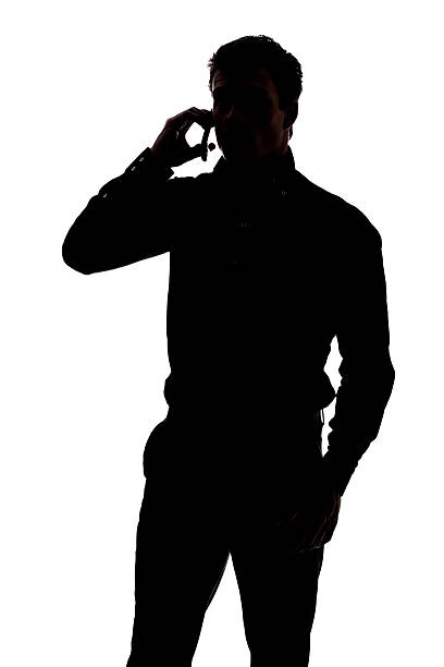 Black and white depiction of man talking on cellphone stock photo