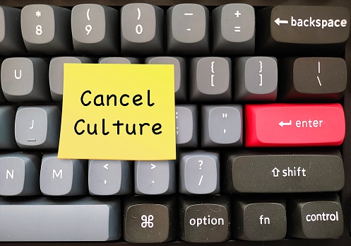 Keyboard with text written on stick note Cancel Culture - refers to mass withdrawal or mass shamimg from public figures or celebrities who have done things that aren't socially accepted, often on social media
