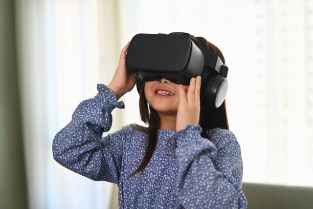 istock Happy schoolgirl using VR glasses for education learning. Future education technology concept. 1842047004