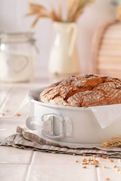 istock Multigrain loaf of round bread with grain and ears. 1842093929