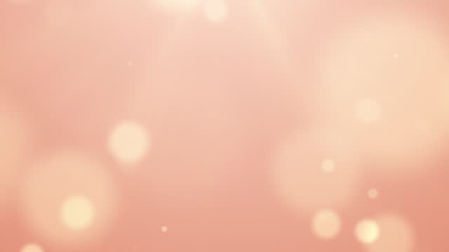 Trend color concept of 2024 Peach Fuzz background bokeh particle abstract blur