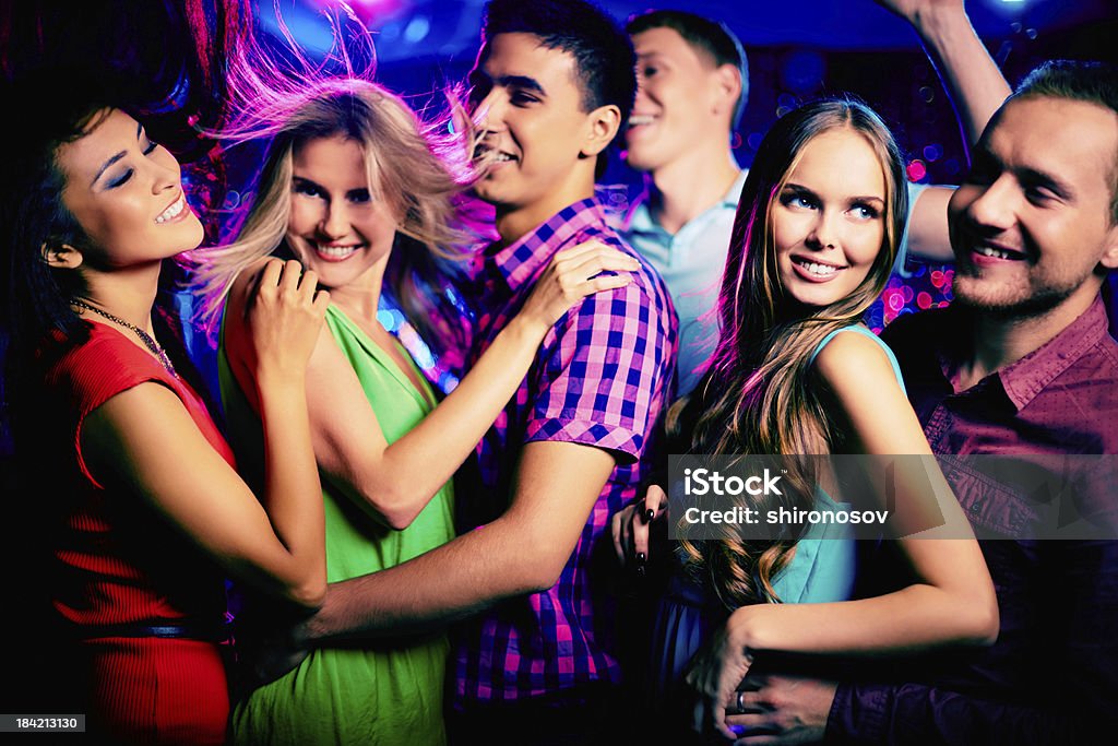 Cool friends Happy young friends dancing at disco Activity Stock Photo