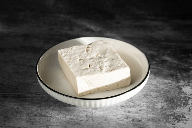 Tofu on plate with black background