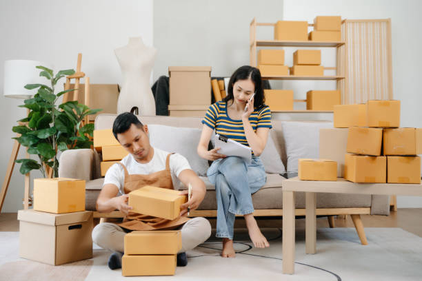 istock Starting small businesses SME owners, two check online orders Selling products working with boxs freelance work at office using tablet and laptop  marketing, packaging, concept 1842150241